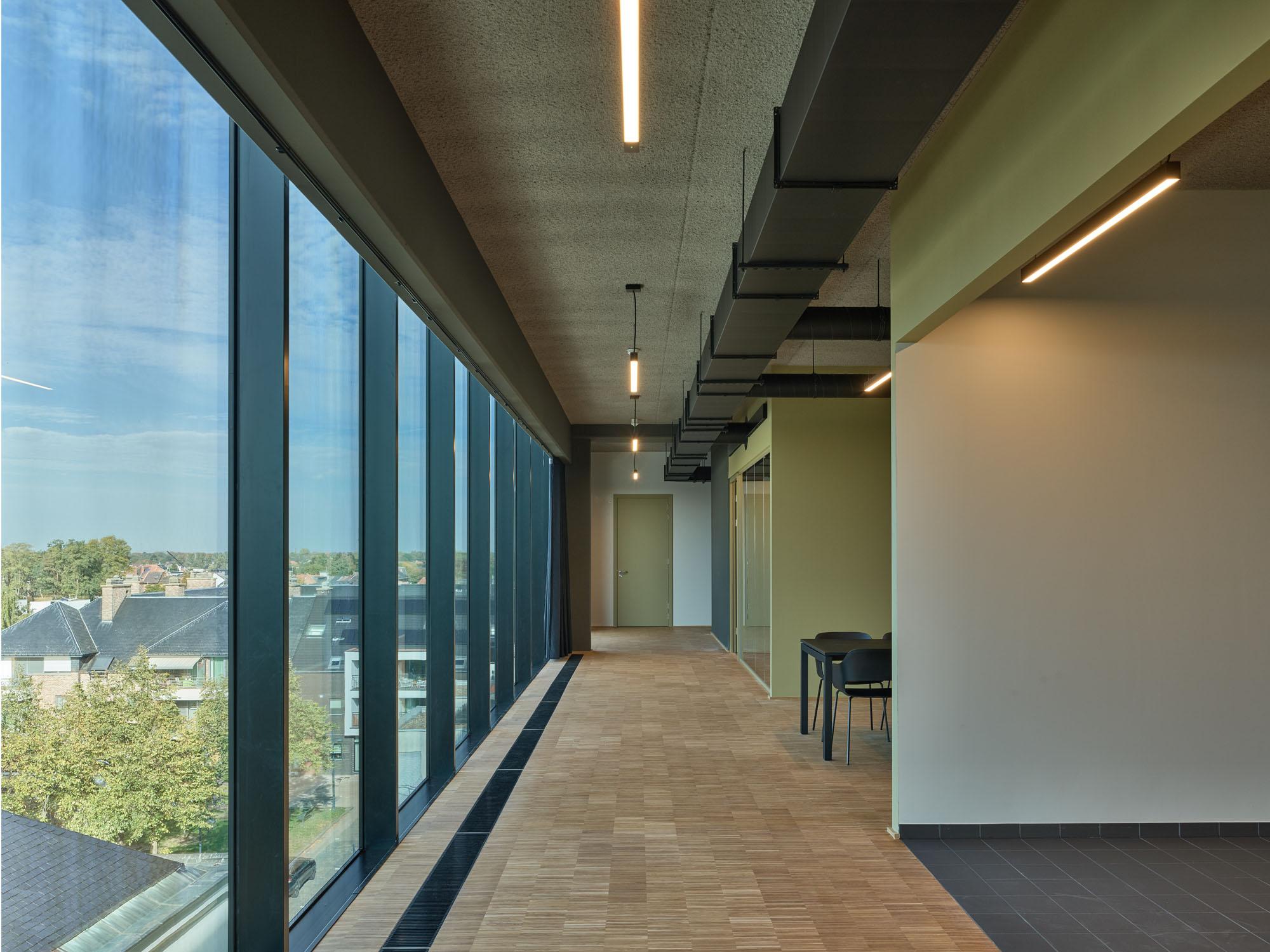 Modern office interior with glass walls and city view in Leopoldsburg, Belgium